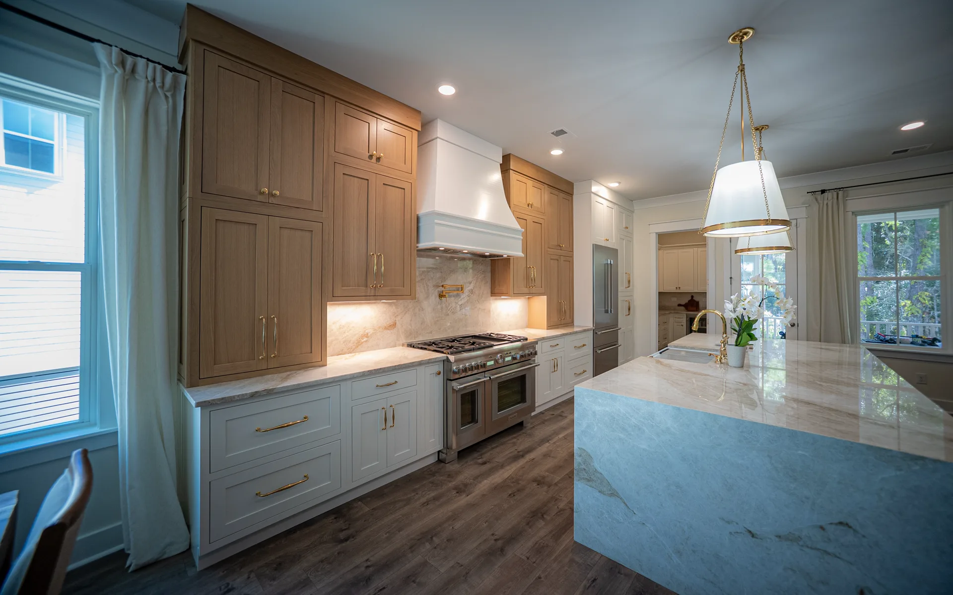 A completed Magnolia kitchen with custom cabinetry and a generous gathering island