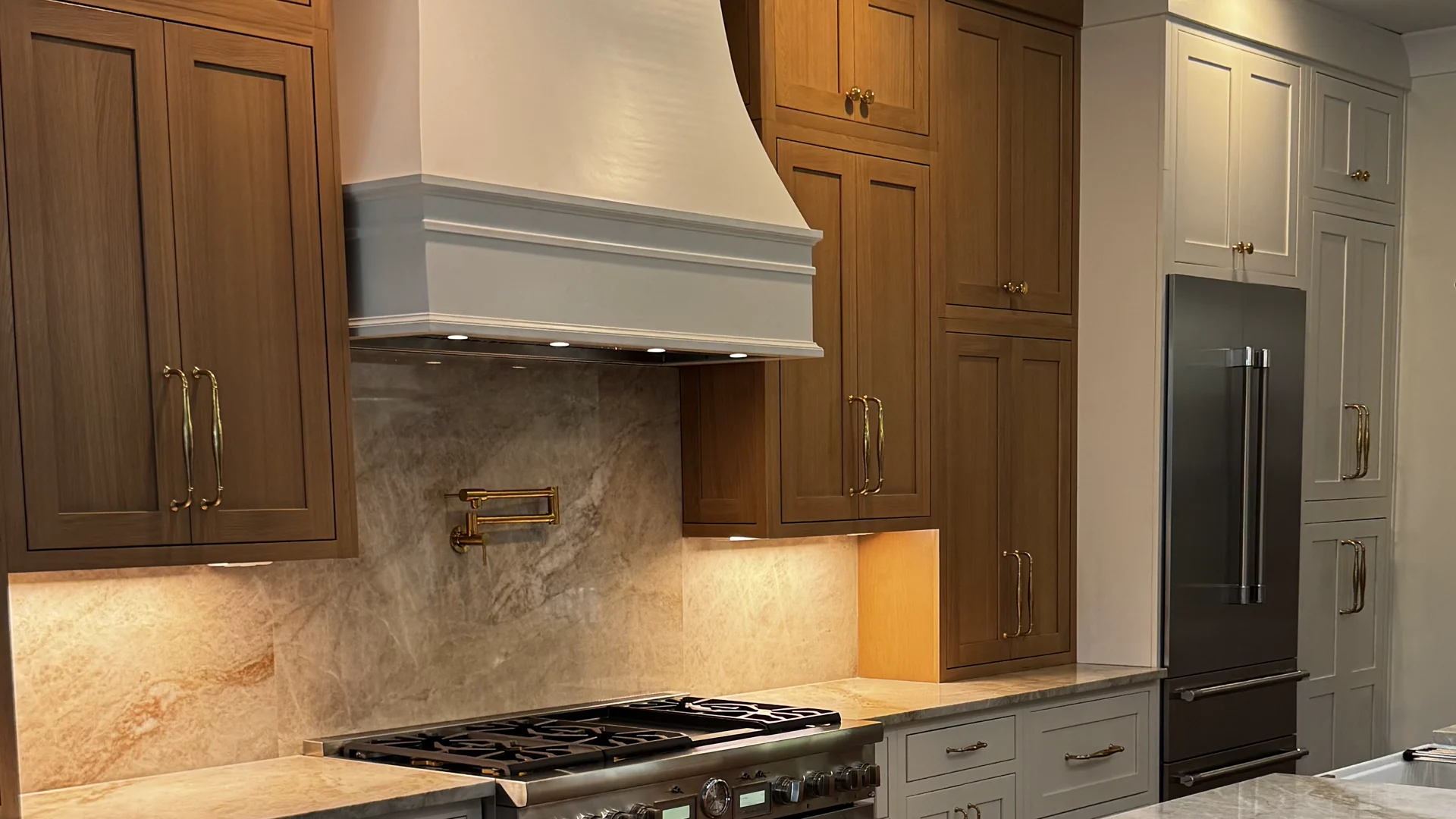 A completed Magnolia kitchen with custom cabinetry and a generous gathering island