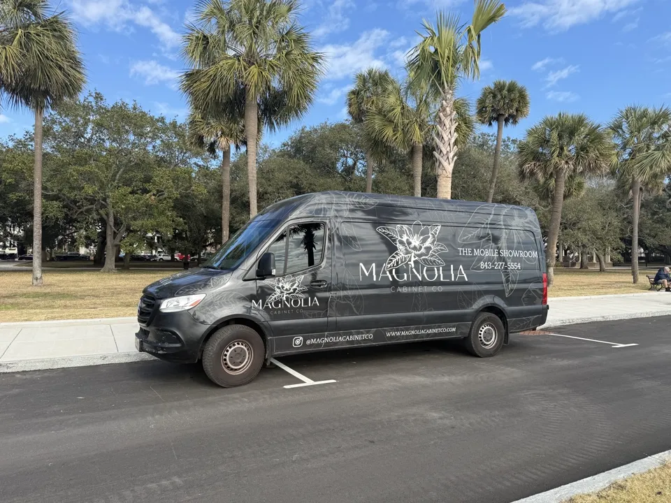 Magnolia Cabinet Co mobile showroom parked outside a home